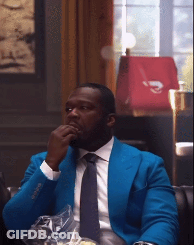 Man In Blue Suit And Tie Sitting GIF