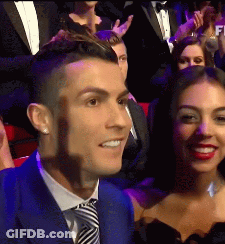 Man In Blue Suit And Tie Smiling Next To Woman GIF