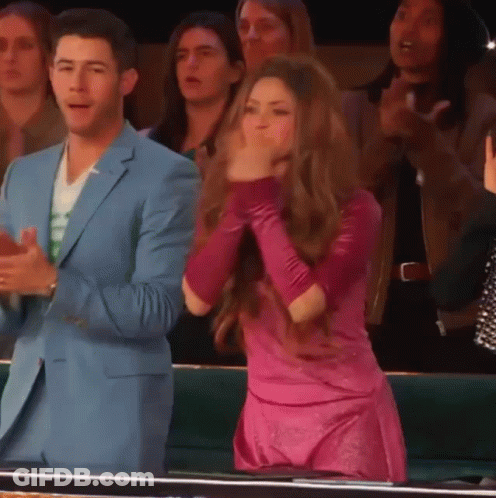 Man In Blue Suit And Woman In Pink Dress Applauding GIF