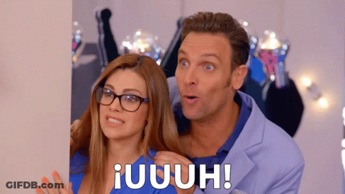 Man In Blue Suit And Woman With Glasses Standing Together GIF