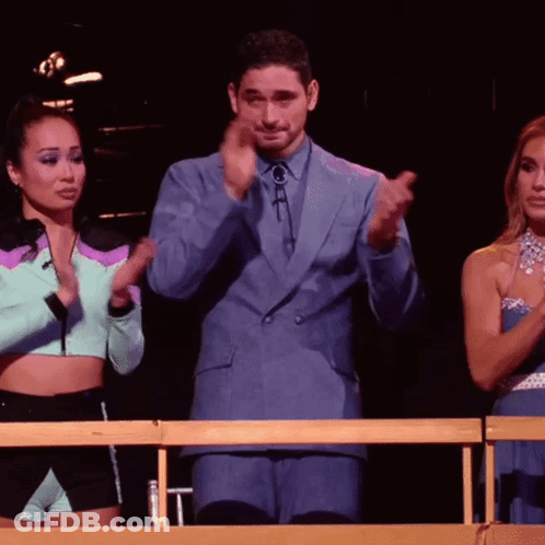 Man In Blue Suit Applauding With Two Women GIF