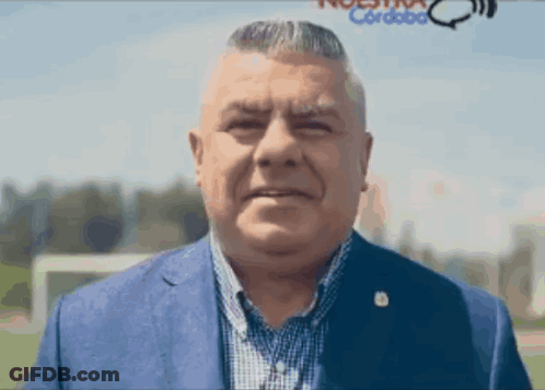 Man In Blue Suit At Nuestra Cordoba Sign GIF