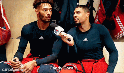 Man In Blue Suit Behind Toronto Maple Leafs Hockey Player GIF