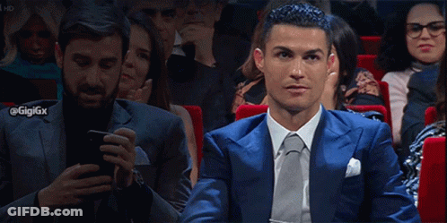 Man In Blue Suit Checking Phone At Theater GIF