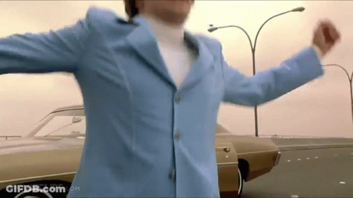 Man In Blue Suit Dancing In Front Of Car GIF