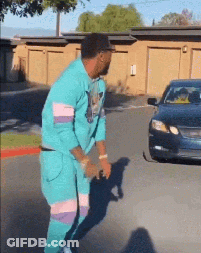 Man In Blue Suit Dancing In Front Of Car GIF