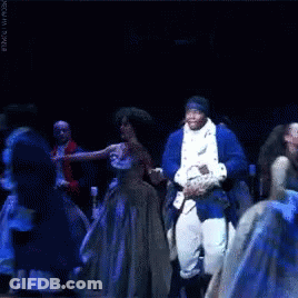 Man In Blue Suit Dancing On Stage With Group GIF