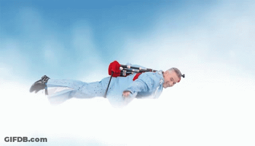 Man In Blue Suit Flying With Red Bag GIF