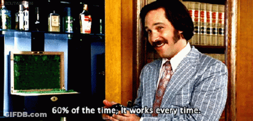 Man In Blue Suit Holding Beer At Desk GIF