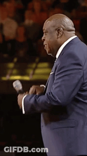 Man In Blue Suit Holding Microphone GIF