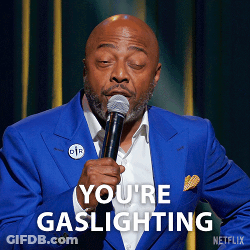 Man In Blue Suit Holding Microphone Saying You're Gaslighting GIF