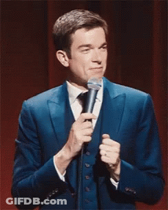 Man In Blue Suit Holding Microphone GIF