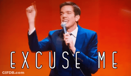 Man In Blue Suit Holding Microphone With Excuse Me GIF