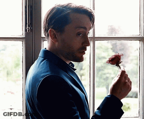 Man In Blue Suit Holding Rose GIF