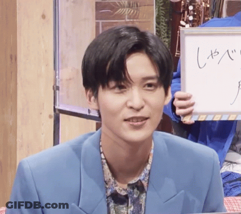 Man In Blue Suit Holding White Board GIF
