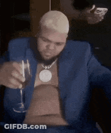 Man In Blue Suit Holding Wine And Smoking Cigarette GIF