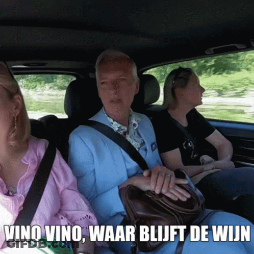 Man In Blue Suit In Car With Two Women Saying Vino Vino GIF