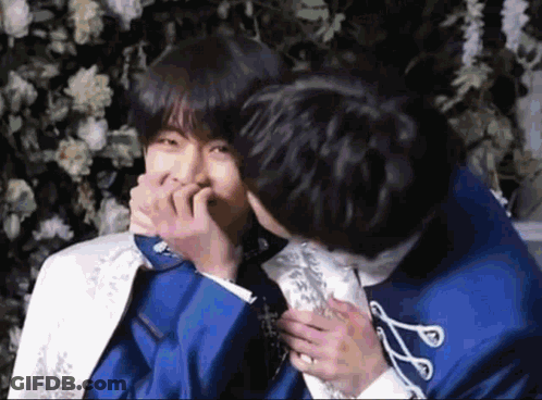 Man In Blue Suit Kissing Man In White Suit GIF