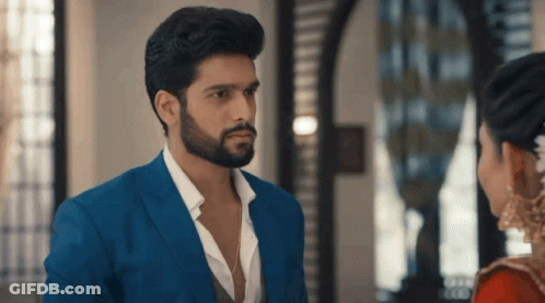 Man In Blue Suit Looks At Woman In Red Dress GIF