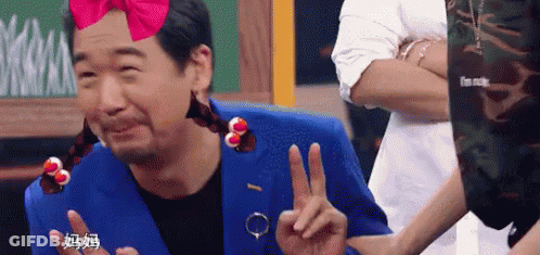 Man In Blue Suit Making Peace Sign GIF