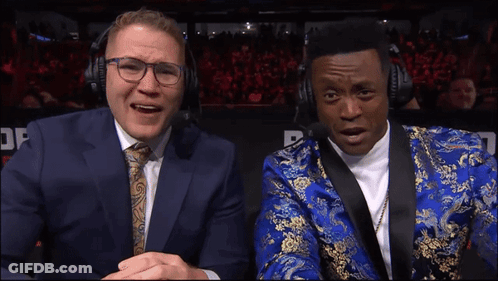 Man In Blue Suit Next To Man In Blue And Gold Suit GIF