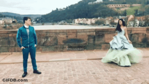 Man In Blue Suit Next To Woman In Green Dress Mayward GIF
