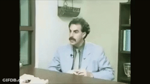 Man In Blue Suit Sitting At Desk GIF