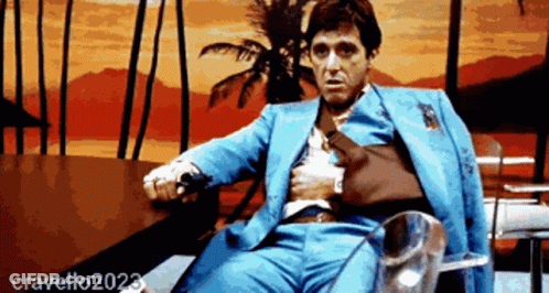 Man In Blue Suit Sitting By Palm Tree GIF