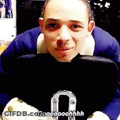 Man In Blue Suit Sitting Holding Purse Saying Oooooohhh GIF
