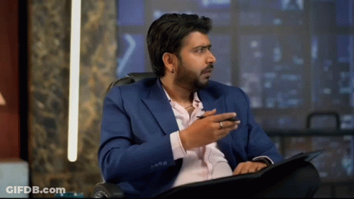 Man In Blue Suit Sitting In Chair GIF