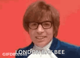 Man In Blue Suit Smiling Saying London Bee GIF