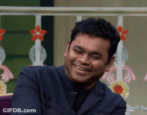 Man In Blue Suit Smiling With A GIF