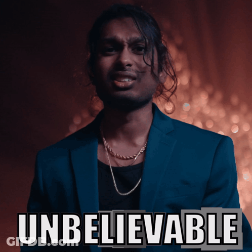 Man In Blue Suit Standing By Unbelievable Sign GIF