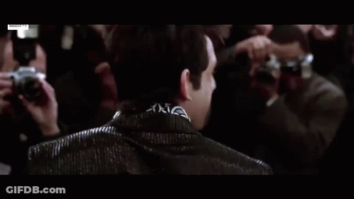 Man In Blue Suit Standing In Crowd GIF