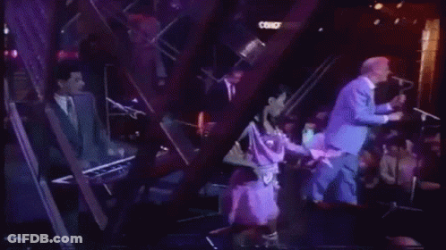 Man In Blue Suit Standing Next To Woman On Stage Saying Leave No Trace GIF