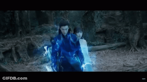 Man In Blue Suit Standing With Woman In Forest GIF