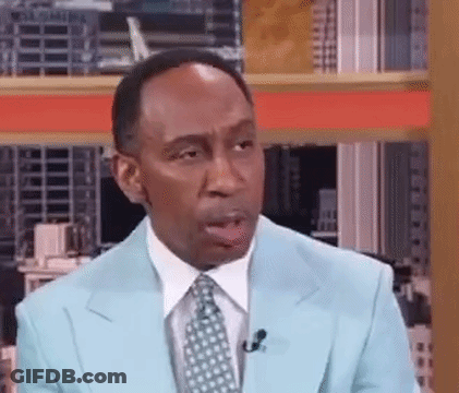 Man In Blue Suit Talking Into Microphone GIF
