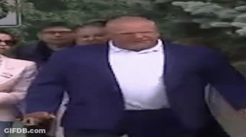 Man In Blue Suit White Shirt Walking With Group GIF