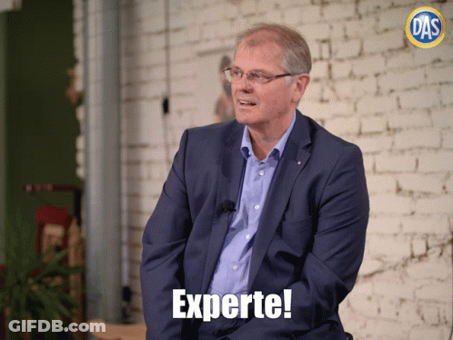 Man In Blue Suit With Experte Text GIF