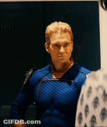 Man In Blue Superhero Costume Standing Next To Man In White Shirt GIF