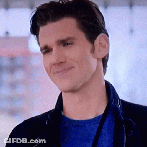 Man In Blue Sweater And Black Jacket Smiling GIF