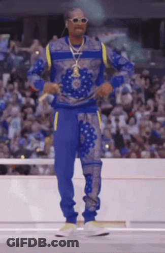 Man In Blue Sweater And Pants In Front Of Crowd GIF