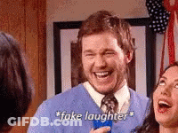 Man In Blue Sweater And Tie Laughing Holding Blue Object GIF