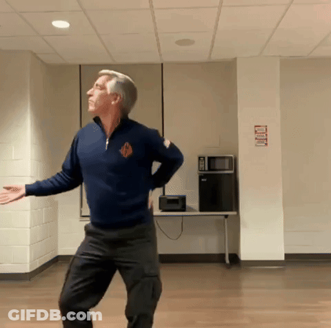 Man In Blue Sweater Dancing With No Smoking Sign GIF
