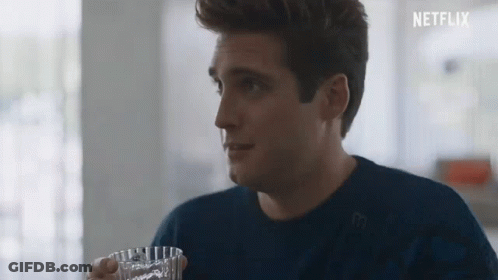 Man In Blue Sweater Holding Glass Of Water GIF