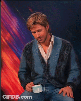 Man In Blue Sweater Holding White Cup GIF