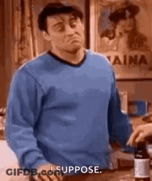 Man In Blue Sweater Holding Wine Bottle GIF