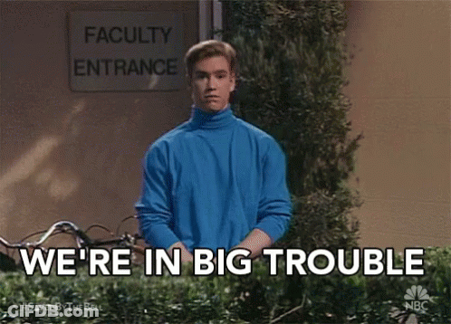 Man In Blue Sweater In Front Of Faculty Entrance Sign GIF