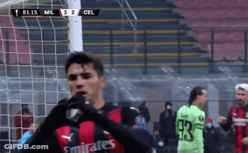 Man In Blue Sweater In Front Of Madrid Wall GIF
