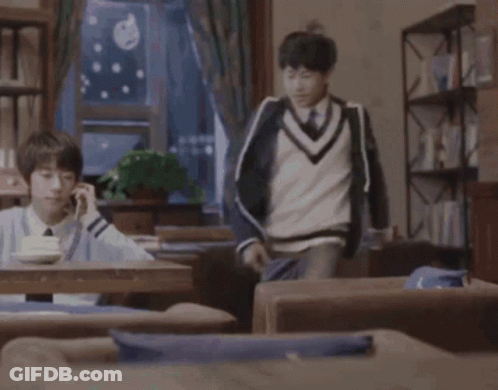 Man In Blue Sweater Kicking Another Man GIF